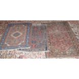 A Middle Easter woollen rug, 135cm x 72cm; another, 90cm x 68cm