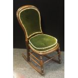 A Victorian rustic oak rocking chair, upholstered back, panel seat, turned forelegs and cross
