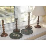 An oak barleytwist candlestick, c.1930; others; side lights; two circular wooden plates, painted