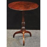 A George III mahogany tilt top occasional table, circular top, turned column. 74cm high x 56cm