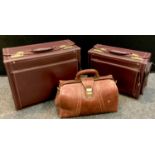 Luggage - a burgundy leather attaché fight case, rectangular hard body with multiple exterior