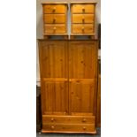 A modern pine double wardrobe, two doors over two long drawers; two 3 drawer bedside chests (3)