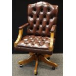 A brown leatherette office swivel chair.