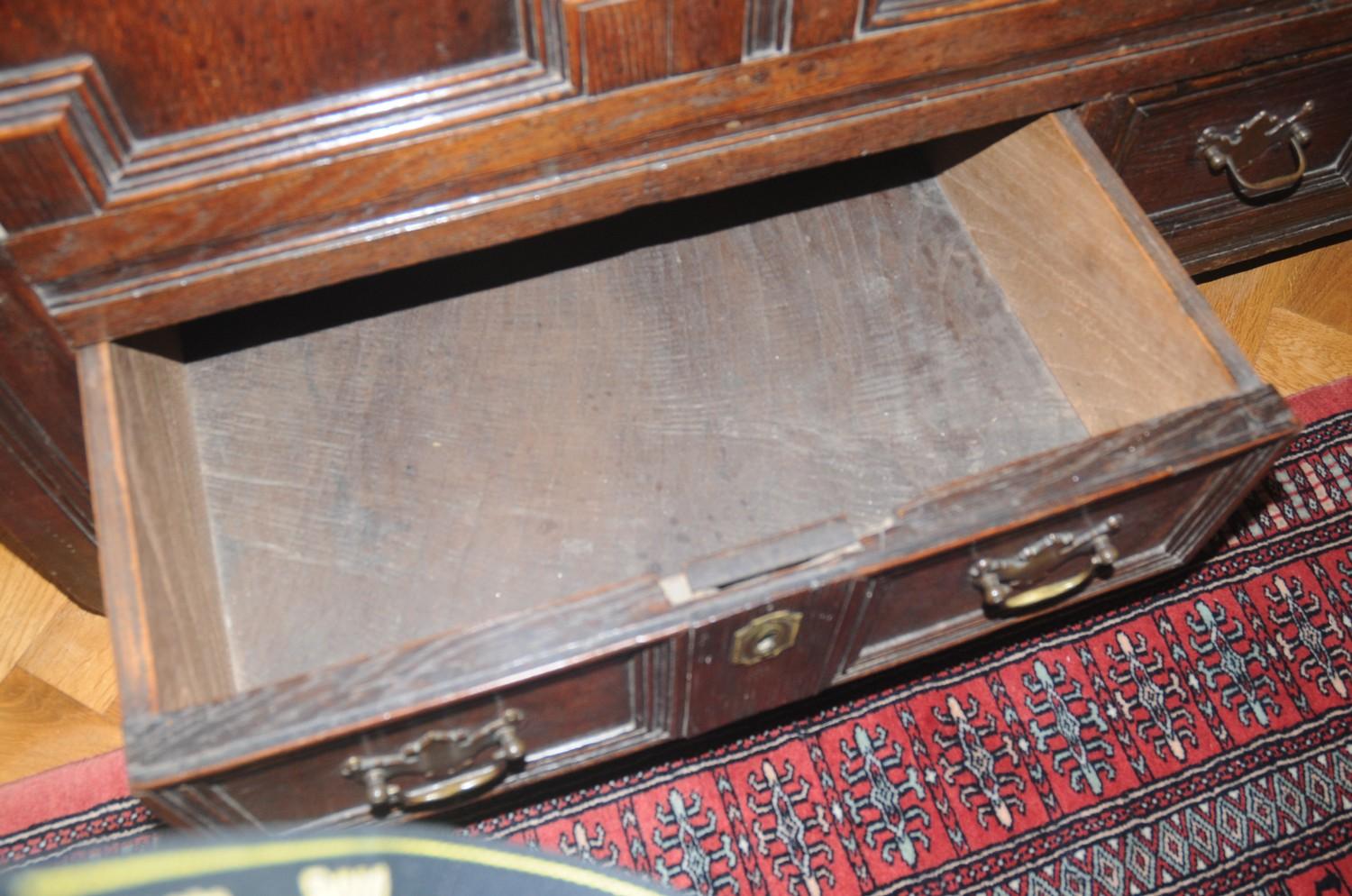 An 18th century oak blanket chest, with panelled top, above field panelled front and two drawers, - Image 2 of 4