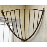 A 19th century corner iron hay rack