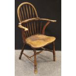 An elm Windsor chair, spindle back, saddle seat, turned legs and H stretcher.