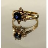 A diamond and deep blue stone, floral cluster ring, open shoulder 9ct gold shank, size O,2.9g gross