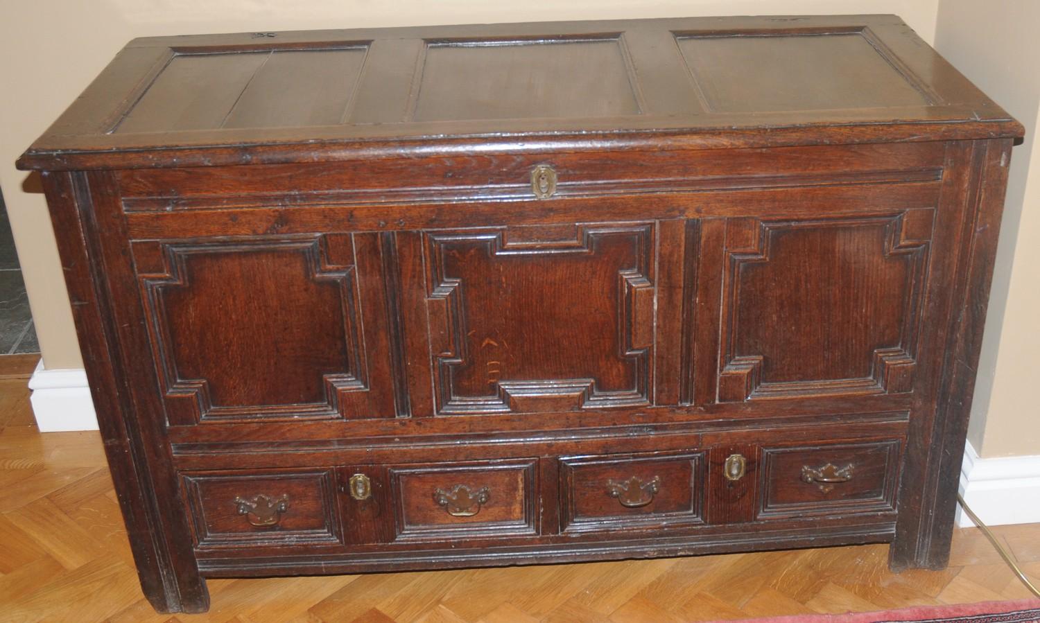 An 18th century oak blanket chest, with panelled top, above field panelled front and two drawers, - Image 4 of 4