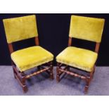 A pair of 17th century design oak side chairs, stuffed-over moss green upholstery, turned legs and