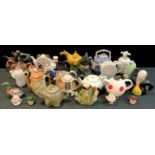 A collection of novelty teapots, including a Tony Wood studio pottery teapot modelled as the Mad