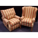 A modern wingback fireside chair. Gold and cream striped upholstery on a terracotta ground; a