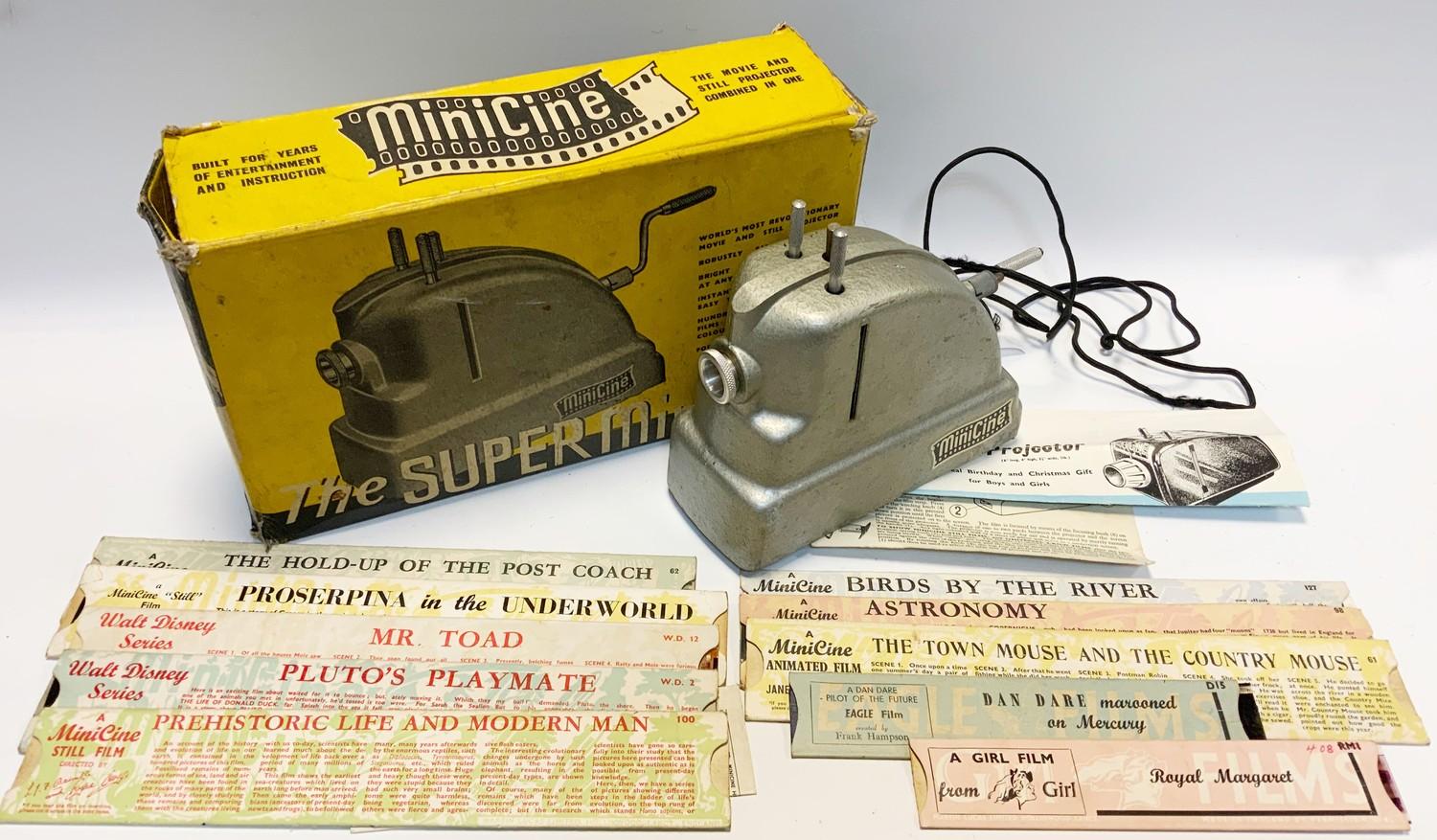 A "Minicine" projector, The Super Minicine with Mini Cine films including Dan Dare marooned on