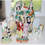 A pair of Staffordshire figures, Scottish huntsman and companion, he with a dog, she with a sheep,