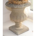 A composition half fluted campana shaped urn, 31cm high