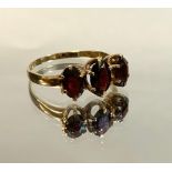 A garnet trilogy ring, graduating oval, deep reddish brown garnets, 9ct gold shank, size P, 1.9g