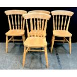 A set of four pine spindle back rustic kitchen dining chairs