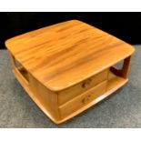 An Ercol 735 model Windsor Pandora golden elm coffee table, rounded square top, twin drawer face,