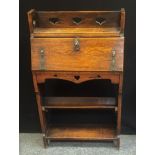 An Arts & Craft oak students Bureau, Heart pierced book rack top, locking fall front, ornate