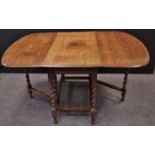 An oak barley twist gate leg table. 74cm high x 106cm wide x 53.5cm opening to 150cm.