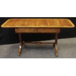A mahogany sofa table, satinwood crossbanded top, two drawers to frieze, roundel escutcheons, loop