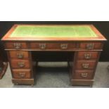 A reproduction mahogany pedestal desk, leather inlaid top, an arrangement of 9 drawers