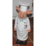 A novelty cast iron door stop, as a pig in a chefs uniform, 58cm high