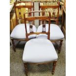 A set of three Edwardian carved back salon chairs, upholstered seats, turned tapering supports c.