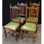 A set of four oak dining chairs, arched top rail, barleytwist uprights, drop in seat, cup and