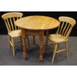 A pine dropleaf table and two lath back chairs. (3)