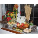 A bowl of faux fruit; pine cones; faux flowers; etc