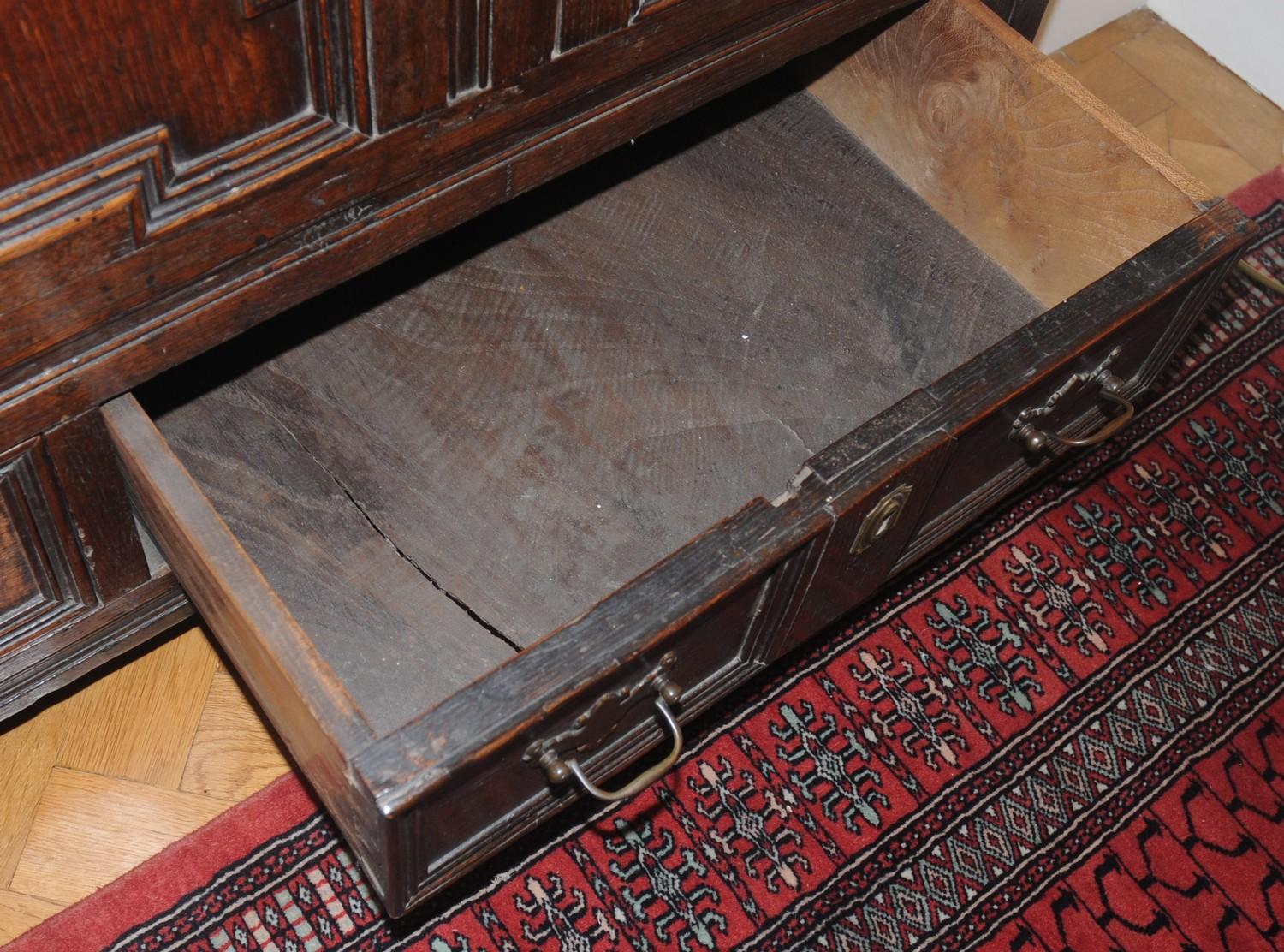 An 18th century oak blanket chest, with panelled top, above field panelled front and two drawers, - Image 3 of 4