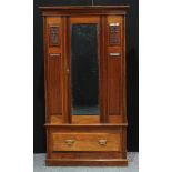 A mid 20th century mahogany single wardrobe, outswept cornice above a bevelled mirrored door the