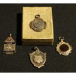 A silver fob medal, Birmingham 1925; other silver fob medals; an enamel bowling fob (4)