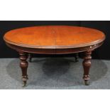 A William IV mahogany extending dining table, moulded top, baluster legs carved with lotus, brass