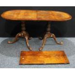 A George III style mahogany dining table, oval top, carved twin pedestals, one additional leaf, 74cm