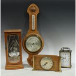 A light oak wheel barometer; a Rapport quartz mantel clock; a Metamec quartz carriage clock; a