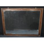 A large rectangular carved oak wall mirror, bevelled edge, 134cm x 99cm overall