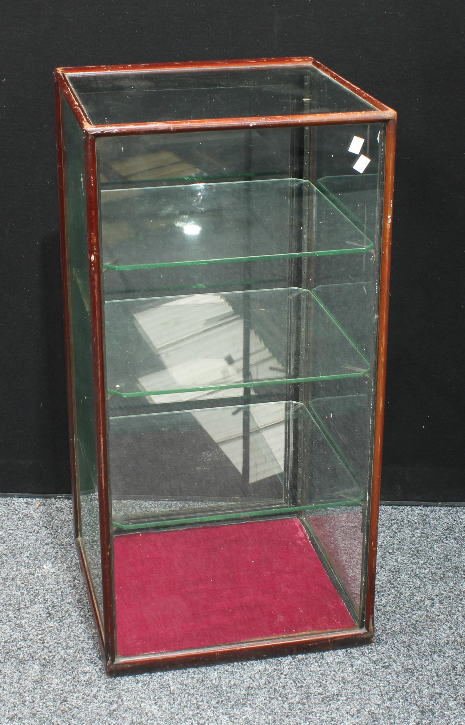 A counter top mahogany shop display cabinet, square top above a glazed door inclosing adjustable