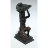A Bergman style bronze, of a 'blackamoor' figure, kneeling, supporting a shell, 32cm high