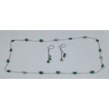 A contemporary modern design emerald green stone inset white gold necklace and earring suite, the