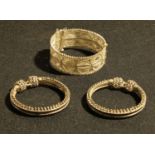 A white metal filigree bangle; another pair of white metal bangles (3)