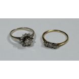 An 18ct gold and platinum three stone diamond ring, 1.45g; an 18ct gold diamond cluster ring, 2.55g,