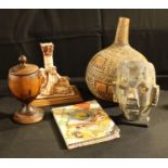 An African carved gourd; a South American decorative mask; a travel journal; a palm wood chalice;