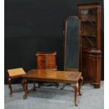 A reproduction mahogany side cabinet, serpentine top above four small cockbeaded drawers, shaped