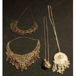 Jewellery - an ornate white metal necklace; others similar; white metal scent bottle on neckchain (