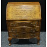 An Art Deco walnut veneered bureau, fall front enclosing a fitted interior above three long