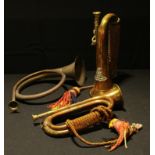 A military style copper bugle with brass badge, tasselled; another similar; a copper horn (3)