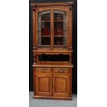 An 'Aesthetic Movement' design bookcase cabinet, dentil cornice above a pair of glazed doors