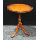 A mahogany oval tripod wine table, 56cm high, 46cm wide