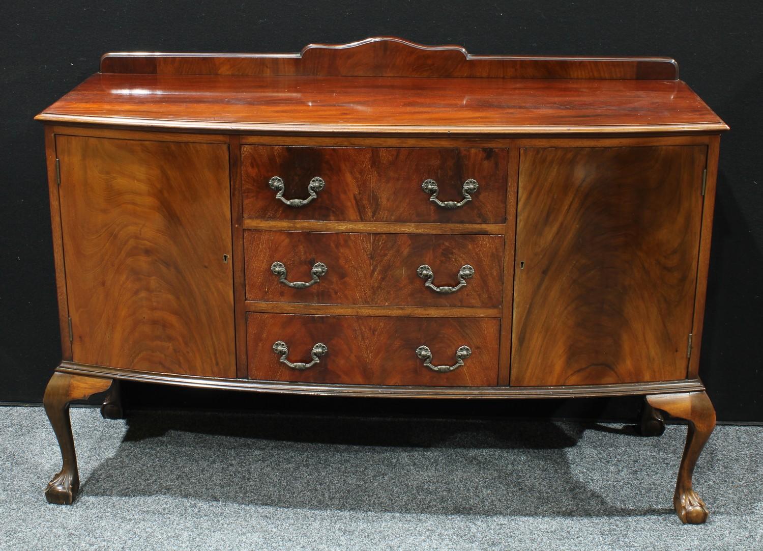 A 20th century mahogany kitchen sideboard, shaped half gallery above a rectangular bow front top,